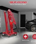 2 Ton Cherry Picker Engine Hoist Folds Flat To Save Bay Space Rolls Smooth On Six Heavy Duty Casters Includes Hand Pump For Garage Crew Auto Projects 4400 Lb with dimensions visible in garage.