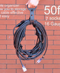 50Ft Weatherproof Outdoor Extension Cord With Seven Inline Outlets, LED Indicator, 16 Gauge 13A 1625W coiled against brick wall