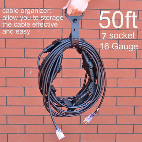 50Ft Weatherproof Outdoor Extension Cord With Seven Inline Outlets, LED Indicator, 16 Gauge 13A 1625W coiled against brick wall