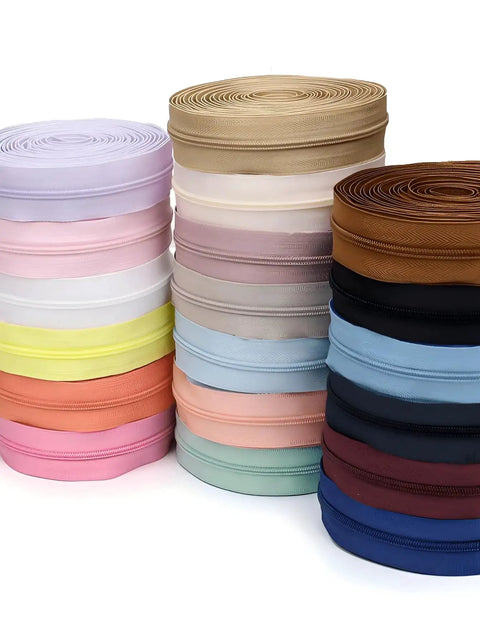 Stacked rolls of colorful zipper tapes from Zipper Upgrade Kit With 4.5m Nylon Tape And 10 Colorful Plastic Pulls Size #3 Zip.