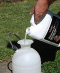 Pouring Masonry Chimney Water Repellent Sealer With Siloxane Formula into sprayer on grass
