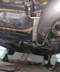 View of undercarriage with Universal Stainless Steel Exhaust Hanger Rods, 7.5 Inch Long, 90 Degree Bend, attached to exhaust system