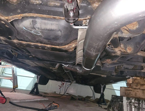 View of undercarriage with Universal Stainless Steel Exhaust Hanger Rods, 7.5 Inch Long, 90 Degree Bend, attached to exhaust system