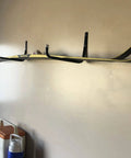 Heavy Duty Steel 10 Inch Garage Storage Utility Hooks 4 Pack Black Powder Coated Rust Resistant Wall Mount Hooks For Tools And Gear For Garage Organization And More, installed on a wall holding a pair of skis.