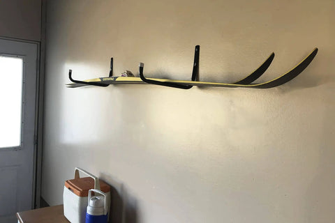 Heavy Duty Steel 10 Inch Garage Storage Utility Hooks 4 Pack Black Powder Coated Rust Resistant Wall Mount Hooks For Tools And Gear For Garage Organization And More, installed on a wall holding a pair of skis.