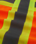 Close-up of Heavy Duty Neon Orange Mesh Safety Vest With Seven Pockets And 3M Reflective Tape showcasing reflective strips.
