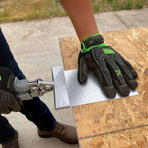 Sheet Metal Hand Seamer With 1/4 Inch Increment Marks in use on a metal sheet, showcasing heavy-duty steel build and comfortable grip.