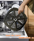 Person holding a Premium Air Fryer Crisper Tray For Dash Mini 2.6 Qt above a dishwasher, showcasing dishwasher-safe feature.