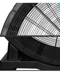 24 Inch Straight Up Heavy Duty Industrial Electric Floor Fan Rolling On Caster Wheels For Built Like A Tank Durability and Kickin Up Major Workshop Warehouse Cooling Performance side view showing steel housing and support base.