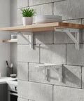 Foldable Stainless Steel Shelf Brackets For Wall Mounts installed with wooden shelf and folded bracket below