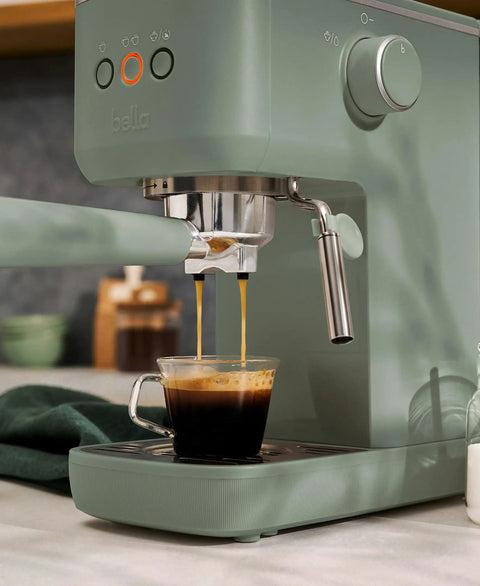20 Bar Slim Espresso Maker With 1300 Watt Pump And 360 Degree Steam Wand For Silky Microfoam brewing espresso in a glass cup.