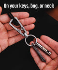 Titanium Mini Infinity Mechanical Pencil Ultra Lightweight Compact Retractable Tip Portable Keychain Writing Tool Includes Two Replaceable Tips For Everyday Quick Notes And On The Go Sketching attached to keychain in hand.