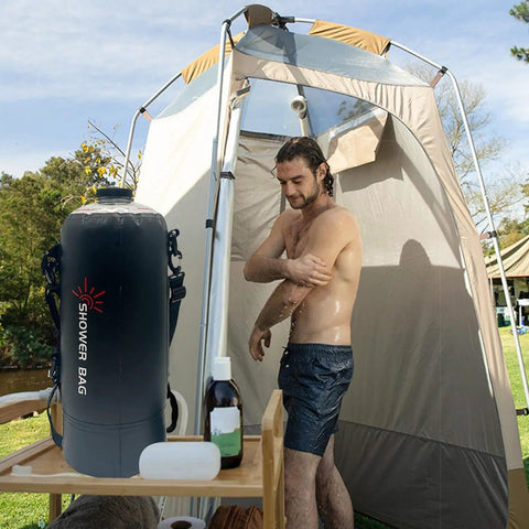 Man using Foldable 12L Solar Heated Camping Shower Kit With Removable Hose And Showerhead For Beach Trips Hiking Travel And Outdoor Adventures Eco Friendly Hot Water On The Go in tent