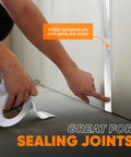 Person applying Two Inch Aluminum Foil Tape With No Release Liner 230 Feet Of Heavy Duty Silver HVAC Duct Tape For High Temperature Insulation Vents Electronics And Dryers on a seam.