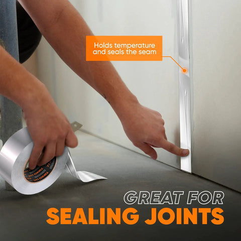 Person applying Two Inch Aluminum Foil Tape With No Release Liner 230 Feet Of Heavy Duty Silver HVAC Duct Tape For High Temperature Insulation Vents Electronics And Dryers on a seam.