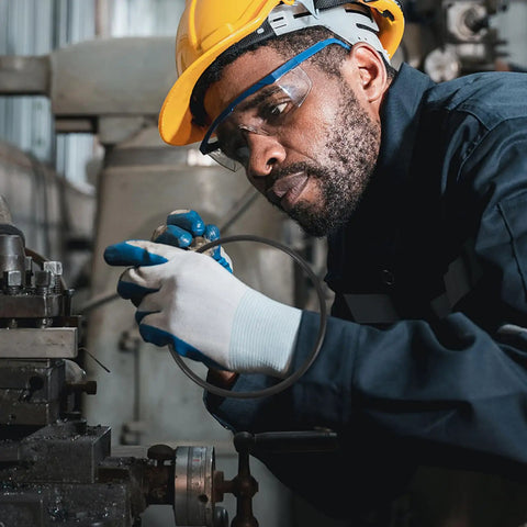 Worker installing Built Tough Rubber Belt Pack For 770 And 900 Continuous Sealers Smooth Transport Feed in industrial setting.