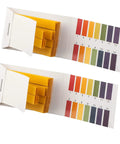 Two open packs of PH Indicator Strips Short Range Test Paper Litmus Strips For Home Use with pH 1-14 color chart