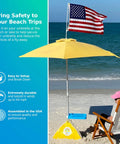 Ultra Beach Umbrella Base for 7.5 ft umbrellas, 75 lb weight, set up on a windy beach with American flag and water-repellent feature.