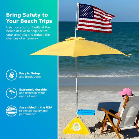 Ultra Beach Umbrella Base for 7.5 ft umbrellas, 75 lb weight, set up on a windy beach with American flag and water-repellent feature.