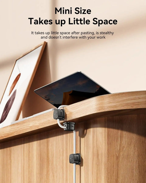 Magnetic Cable Clips Cord Organizer 30 Pack installed on wooden surface managing cables with tablet and picture in background
