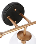 Black And Gold Three Light Vanity Light Fixture With Seeded Glass Shades And Black Backplate For Modern Bathrooms Over Vanity Mirror Dope Glam Glow That Elevates Your Powder Room And Guest Bath Vibe In A Modern Home close-up of backplate and arm design