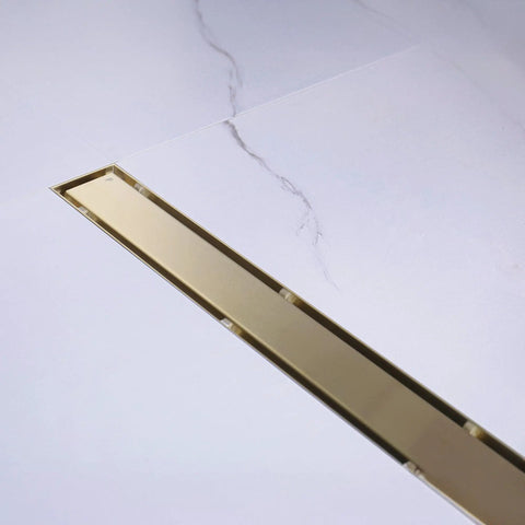 Rugged 42 Inch Linear Shower Drain With Flip Style Tile Cover And Sleek Satin Brass Trim Crafted From Bulletproof 304 Stainless Steel, installed.