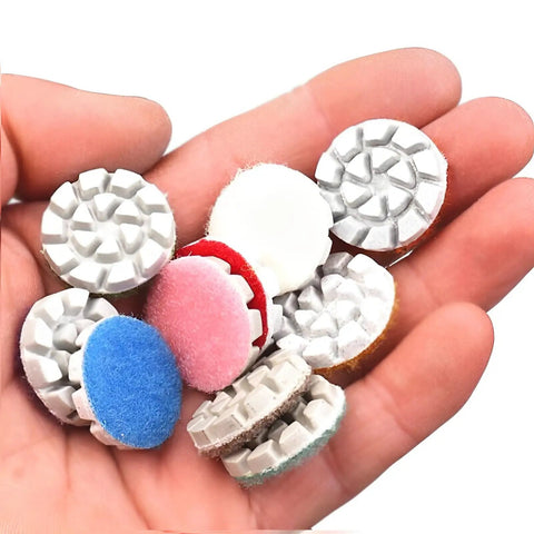 Hand holding Mini Diamond Polishing Pad Set 1 Inch With 14 Grits From 50 To 10000 Water Sanding Discs