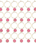 Close-up of Rose Red Enamel Alphabet Charms And Golden Wine Glass Marker Rings Set Including 52 Alphabet Charms And 60 Marker Rings For Wine Tasting Parties Party Favors Gift Decor And Beading Hoops For Diy Jewelry Or Crafts, showcasing assorted letter charms on gold rings.