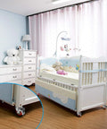 PRITEK 5-inch plate caster wheels, 4-pack with brakes on a white baby crib; red wheel hubs (front view).