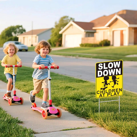 Slow Down Children At Play Safety Signs 2 Pack 17 By 13 Inch Double Sided Corrugated Plastic With H Metal Stakes displayed on lawn.