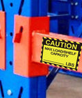 Pro Grade Pallet Rack Capacity Labels 3X4 Inch Maximum Load Warning Stickers 25 Pack on a blue and orange shelving unit.