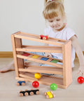 Child playing with Wooden Race Track Ramp Toy For Toddlers 5 Level Car Ramp Set With 4 Wood Cars And 3 Balls No Assembly