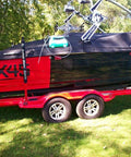 Red and black boat on a trailer, suitable for use with LiquiVac MarinaPro 5000MP 8Qt Fluid Extractor For Boats And Small Engines.