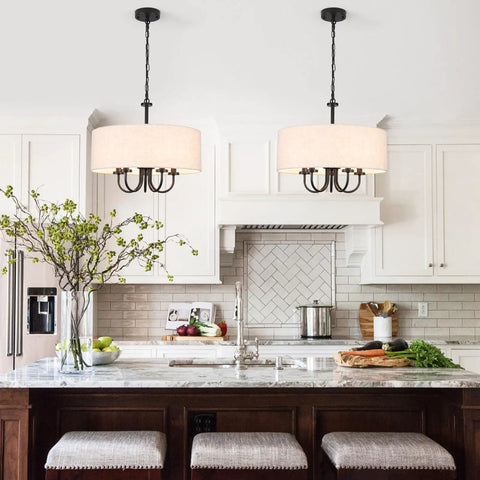 Modern kitchen with pendant lights over island, white cabinetry, and bar stools