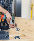 Person using Blue Anti Rust Coated Two And A Half Inch Pocket Hole Screws 300 Piece Set With Washer Head for wood joinery