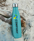 Snag Our Fly Custom 17 Oz Insulated Water Bottles With Double Wall Stainless Steel Build Plus Leak Proof Reusable Design Great For Sports Travel And Gym Workouts White Bulk 100 Pack Holds One Hundred Cups Ideal Kick Back Drinkware Vacuum Sealed on sandy background with a log.