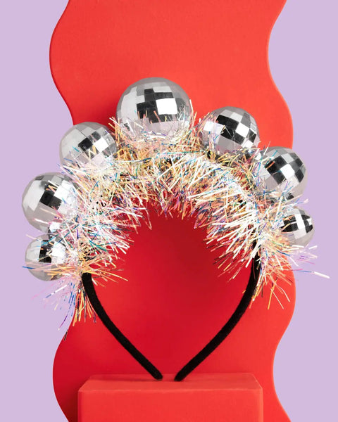 Disco Ball Headband For Parties And NYE Fits Adult And Kid Shiny Foil Crown Against Red Background