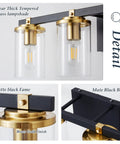 Close-up of 4 Light Modern Vanity Light Fixtures For Bathroom In Matte Black And Brushed Gold With Clear Glass Shades Over Mirror