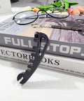 All In One Eyeglasses Repair Kit For Quick Adjustments And Tightening Frames With A Handy Screwdriver Includes Temple Bending Nose Pad Contouring And Replaces Multiple Tools At Home, shown with gray multifunction tool and black-rimmed glasses