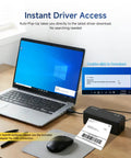 Laptop next to a Bluetooth Thermal Label Printer With Stand Go-To Wireless 4x6 Shipping Label Printer for Small Biz Easy Setup Works With iPhone Android Windows Mac Great For USPS Amazon Etsy Shopify Sleek Black on desk