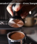 Using the 53.3mm tamper from the 7 Piece Espresso Tools Kit For 54mm Breville Portafilters on coffee grounds in a portafilter.