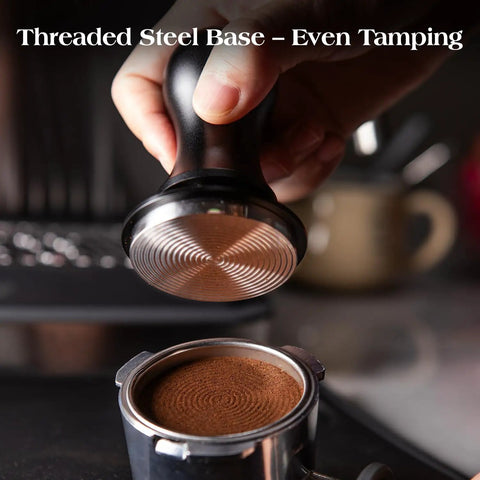 Using the 53.3mm tamper from the 7 Piece Espresso Tools Kit For 54mm Breville Portafilters on coffee grounds in a portafilter.