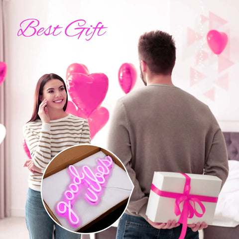 Man holding gift with Pink Good Vibes Neon Sign For Bedroom And Wall Decor, LED Neon Lights For Living Room Or Office inset