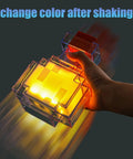 Person holding a yellow Color Changing Potion Bottle LED Table Lamp with shake feature, glowing in the dark