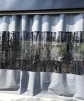 Kickass Clear PVC Tarp Curtains With A Seamless Zipper Door And Heavy Gauge Grommets Level Up Your Pergola Gazebo Or Patio Setup While Blocking Elements Like A Boss Year Round, shown hanging with a clear middle section.