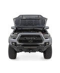 Toyota Tacoma hood open showing hood lift kit with hydraulic hood assist hands free lift no prop rod easy bolt on hood struts pair