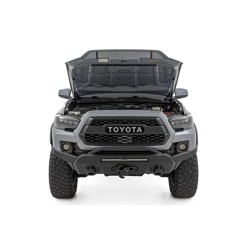 Toyota Tacoma hood open showing hood lift kit with hydraulic hood assist hands free lift no prop rod easy bolt on hood struts pair