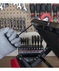 Cool Star Shaped T Handle Hex Key Tool Set For Metric And Imperial Sizes Perfect For Vehicle Maintenance Or DIY House Repairs With Strong Grip To Loosen Tight Fasteners Easily Without Breaking A Sweat., gloved hand using black T-handle hex key on metal frame