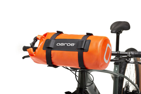 Spider Handlebar Cradle With 8L Heavy Duty Dry Bag For MTB Gravel And EMTB Bikes attached to a bicycle, showcasing quick release mount.