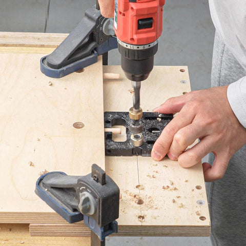 Person using Pro Shop Quality High Precision Woodworking Hole Punch Tool Dowel Jig For Accurate Hole Location In Furniture Assembly And DIY Projects Aluminum Alloy Construction For Long Lasting Performance with drill on wood panel